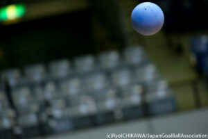 A goalball flies through the air