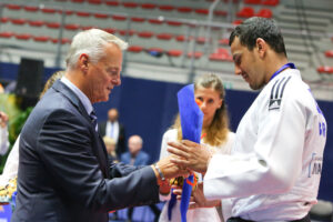 Elliot Stewart receives his European bronze medals and flowers