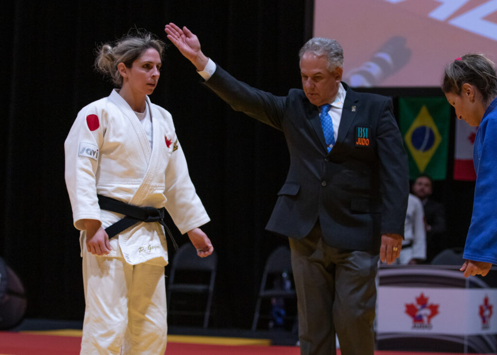 Priscilla Gagne is awarded the win by the referee as she stands opposite her opponent