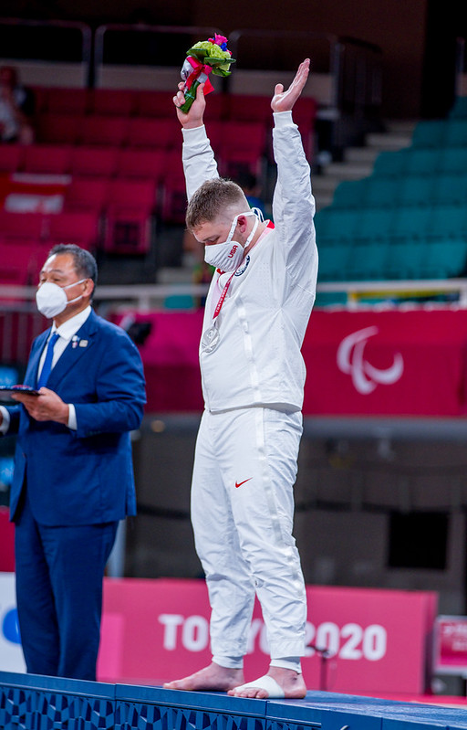 Benjamin Goodrich holds his hands in the air after receiving his silver medal at Tokyo 2020