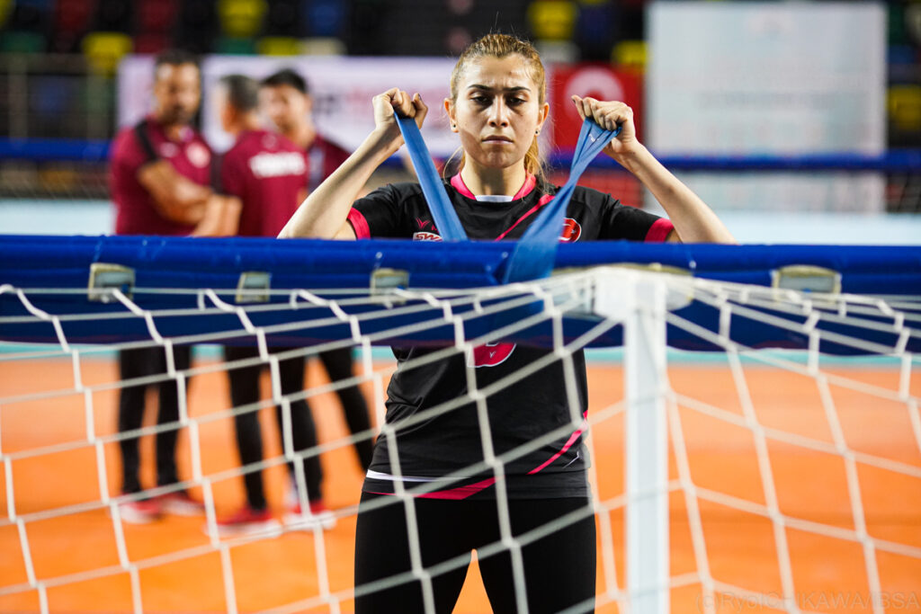 Turkey's Sevda Altunoluk completes a warm up using stretch fabric attached to the goal
