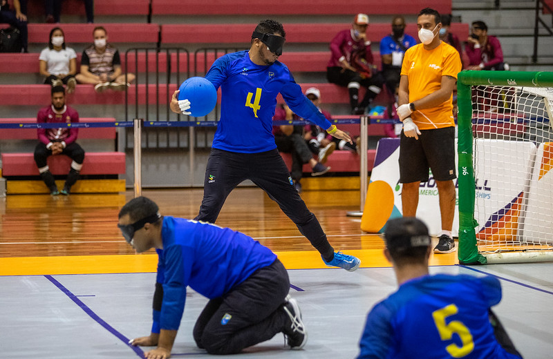 A Brazilian goalball player rotates in front of goal with the goalball in his hand during a shot
